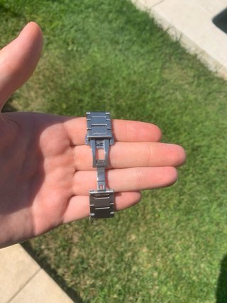 Reloj plateado con esfera azul.