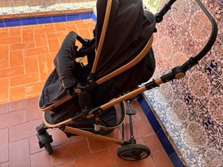 Carrito de bebé negro y dorado