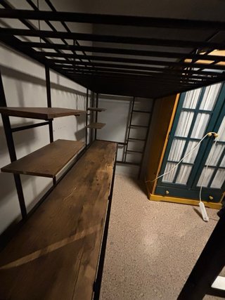 Cama loft negra con escritorio y estantes
