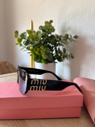 Gafas de sol Mïu Mïu negras y doradas