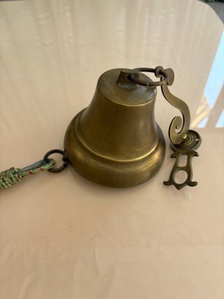 Campana de latón con cuerda y bola decorativa
