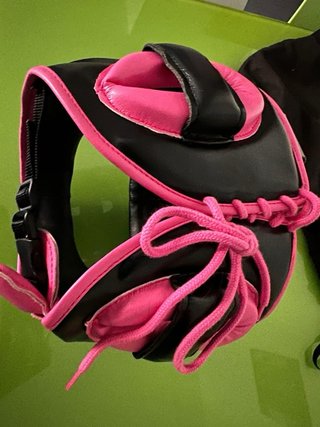 Casco de boxeo FLY negro con borde rosa.
