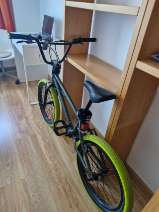Bicicleta BMX verde con ruedas amarillas