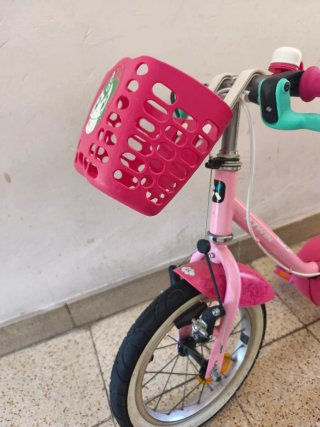 Bicicleta infantil rosa con cesta y casco