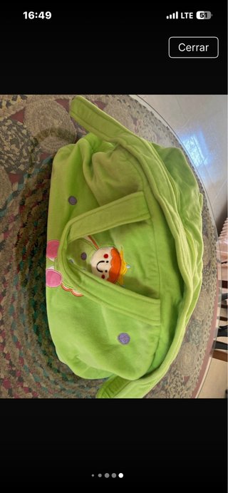 Bolso de bebé verde con muñeco