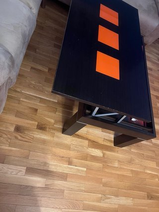 Mesa de centro elevable negra con detalles naranja