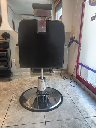 Sillón de peluquería negro y plateado