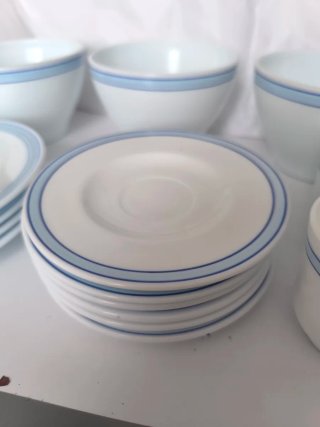 Vajilla tipo arcopal blanca con una linea azul