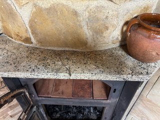 Estufa de leña, de rincón con horno.