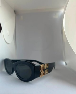 Occhiali da sole Miu Miu neri e oro