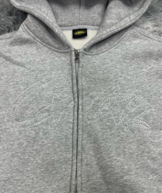 Sudadera gris con cremallera corteiz