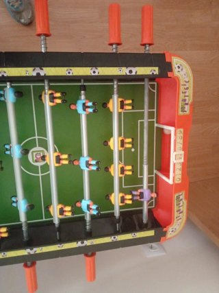 Futbolín de mesa naranja y negro
