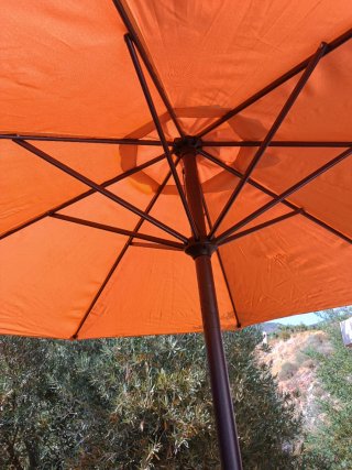 Parasol naranja y pie de hierro forjado