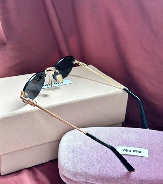 Gafas de sol Miu Miu negras y doradas