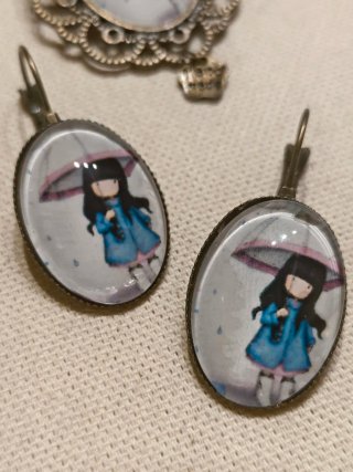 Broche y pendientes con niña bajo paraguas