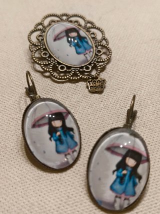 Broche y pendientes con niña bajo paraguas