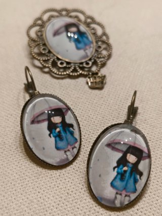 Broche y pendientes con niña bajo paraguas