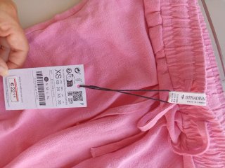 Pantalón largo rosa Stradivarius con etiqueta