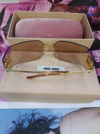 Gafas de sol Miu Miu marrones y doradas