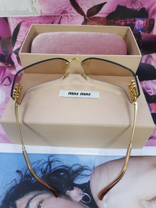 Gafas de sol Miu Miu marrones y doradas