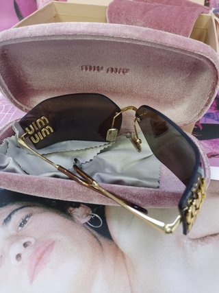Gafas de sol Miu Miu marrones y doradas