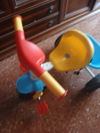 Triciclo infantil amarillo, rojo y azul