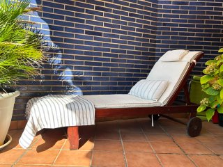 Tumbona de madera con funda