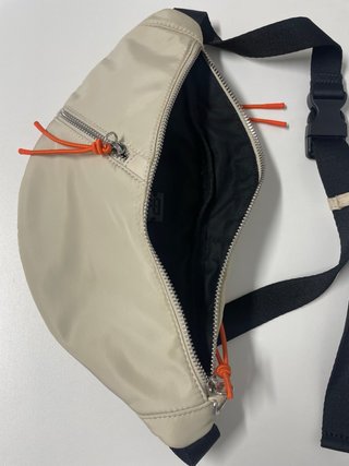Riñonera beige con detalles naranja