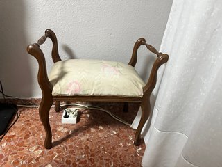 Taburete antiguo tapizado floral y cortinas
