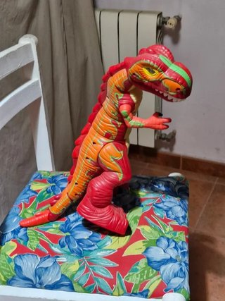 Dinosaurio de juguete rojo y naranja