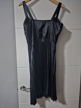 Vestido negro satinado con plisados.