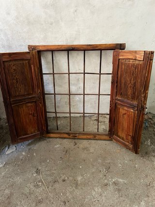 Ventana de madera rústico con puertas y reja