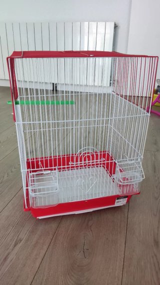 Jaula para pájaros roja y blanca