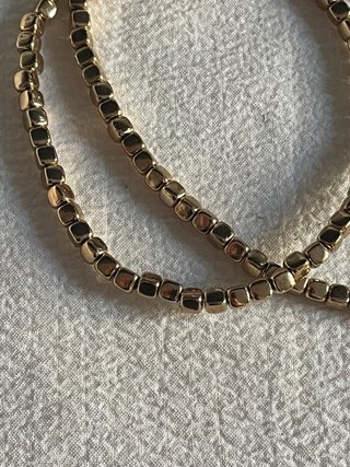 Collana elastica perline quadrate oro