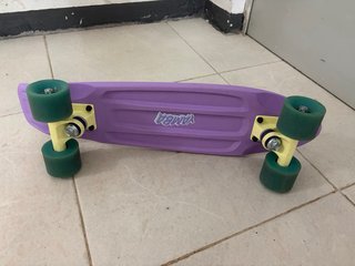 Monopatín morado con ruedas verdes
