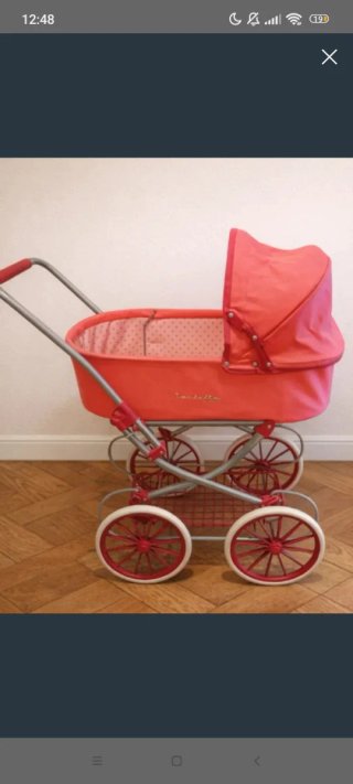 Cochecito de juguete rosa