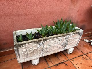Jardinera de piedra con relieve
