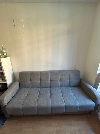 Sofá cama gris de tela