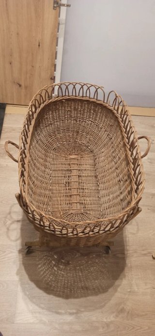 Cuna de mimbre antigua con ruedas