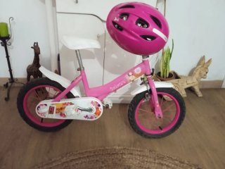 Bicicleta infantil rosa con casco