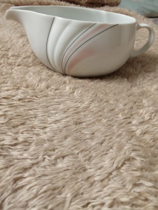 Salsera de porcelana blanca con detalles rosas
