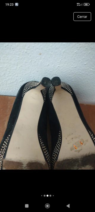 Zapatos de tacón negros con detalles plateados.