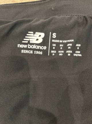 Pantalón corto running New Balance 2 en 1. T-S.