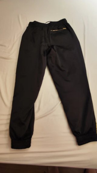 Pantalón chándal Puma negro y dorado