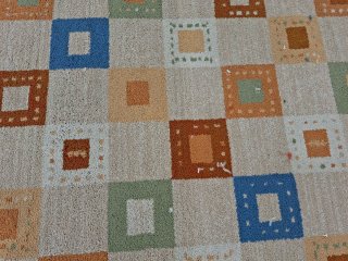 Alfombra beige y multicolor de tela