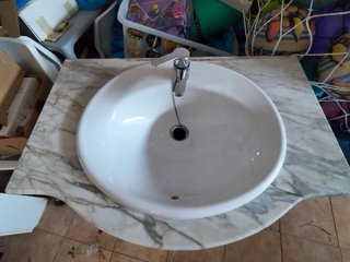 Lavabo con mueble de madera y mármol