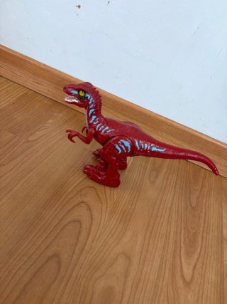 Dinosaurio de juguete rojo y azul