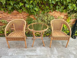 Tavolo rotondo in vetro e rattan per esterni
