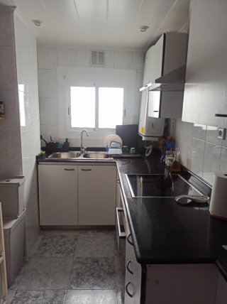 Cocina blanca y negra con encimera de granito