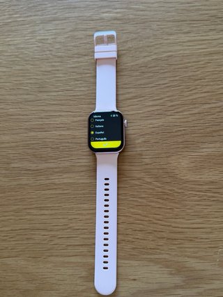Smartwatch rosa con cargador y manual
